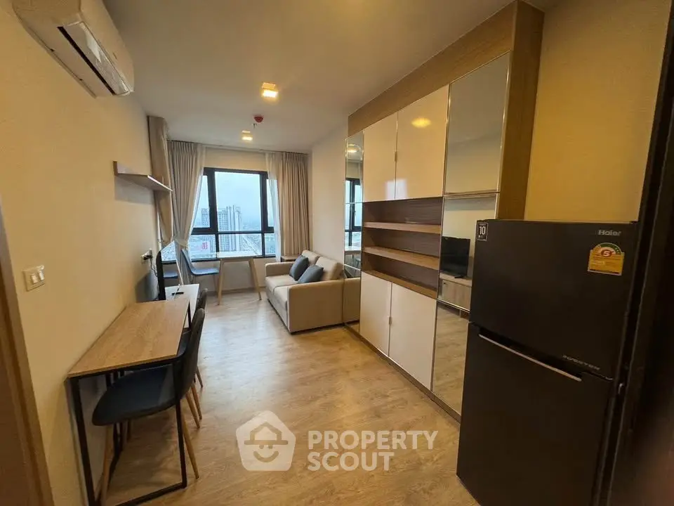 Modern living room with city view, stylish furniture, and sleek design in a high-rise apartment.