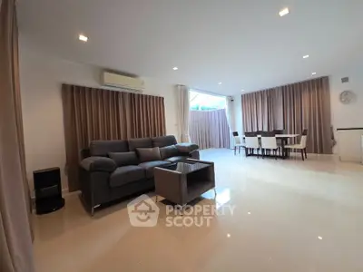 Spacious living room with modern furniture and large windows for natural light.