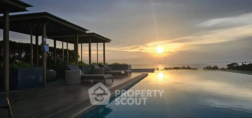 Stunning sunset view from luxurious rooftop infinity pool with elegant seating area.