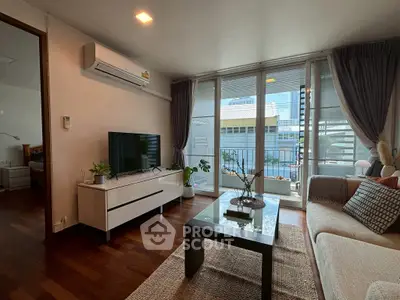 Stylish living room with modern decor and large windows offering city views.