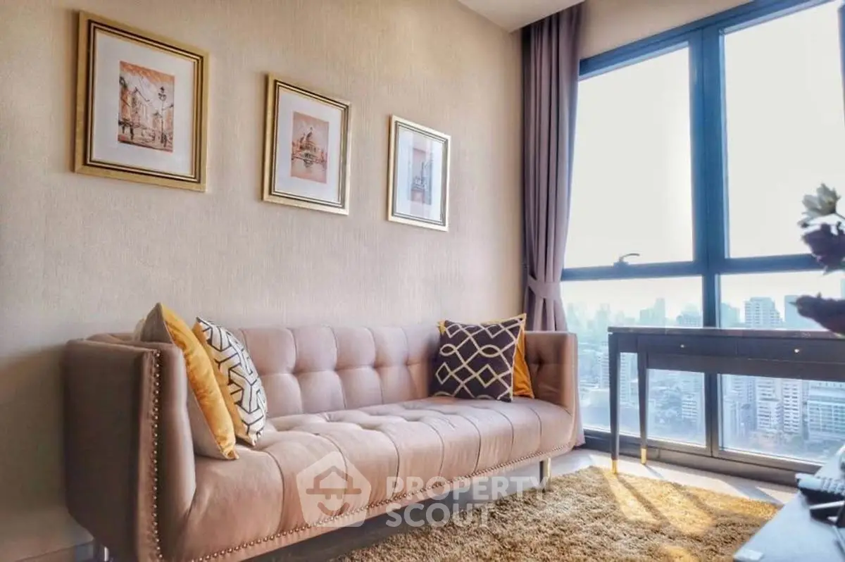 Stylish living room with plush sofa and city view through large windows.
