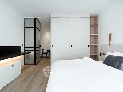 Modern minimalist bedroom with sleek design and ample storage space.