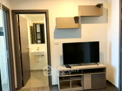 Modern apartment interior with TV unit and bathroom view, ideal for urban living.