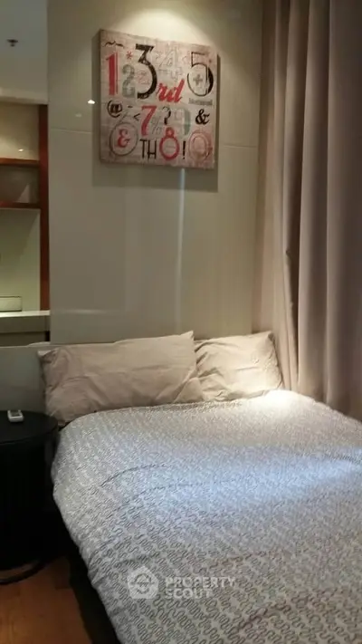 Cozy bedroom with modern decor and soft lighting, perfect for relaxation.