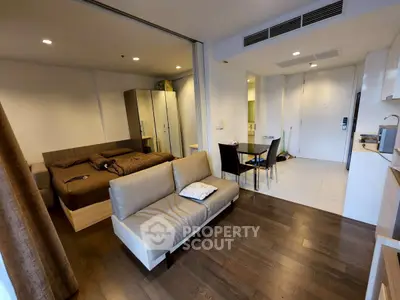 Modern studio apartment with open layout, featuring a cozy living area and stylish kitchen.