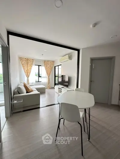 Modern living room with open layout, stylish furniture, and natural light in a contemporary apartment.