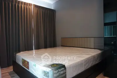 Spacious bedroom with high-quality mattress and elegant curtains