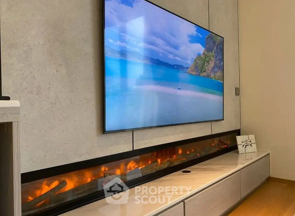 Modern living room with sleek wall-mounted TV and stylish electric fireplace.