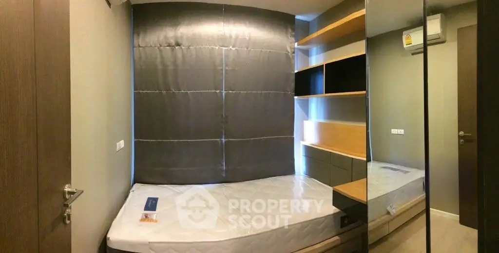 Modern bedroom with sleek design and built-in storage solutions.