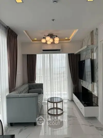 Modern living room with elegant decor and large windows