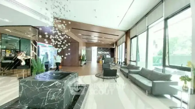 Luxurious modern lobby with elegant marble fountain and stylish seating area