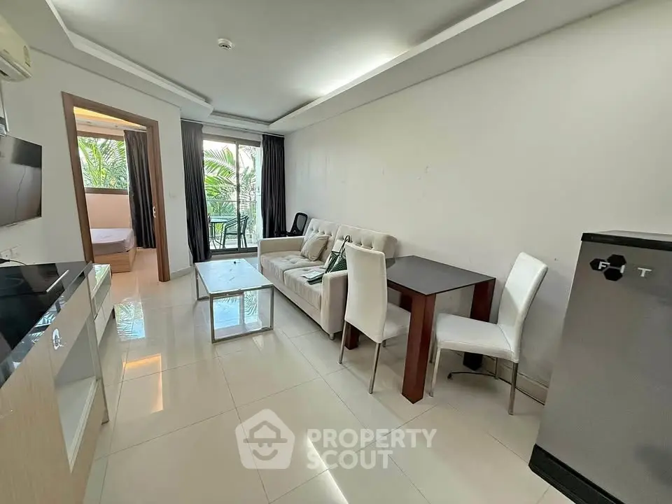 Modern living room with sleek furniture and open layout, featuring a cozy balcony view.