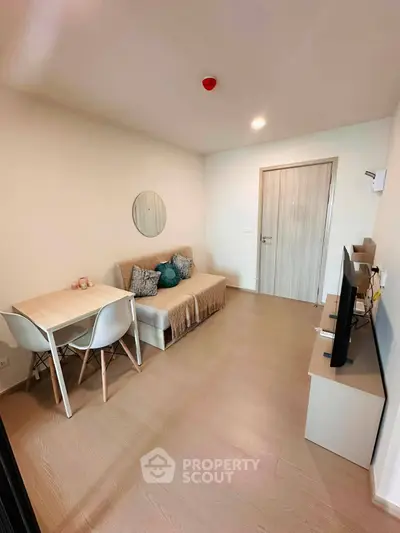 Cozy living room with modern decor, featuring a comfortable sofa, stylish table, and flat-screen TV for ultimate relaxation.