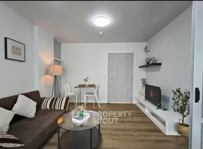Modern living room with cozy sofa and stylish decor in a contemporary apartment.