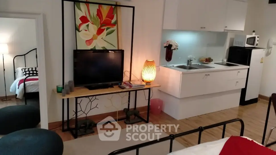 Charming studio apartment with modern kitchen and cozy living area, perfect for urban living.