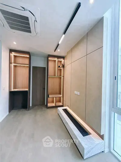 Modern minimalist living room with built-in shelves and sleek lighting