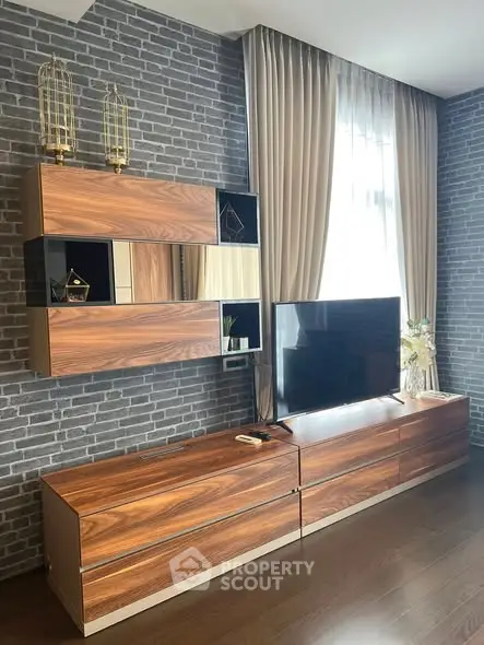 Modern living room with stylish wooden furniture and brick accent wall