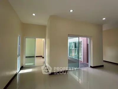 Spacious modern interior with sliding glass doors and ample natural light.