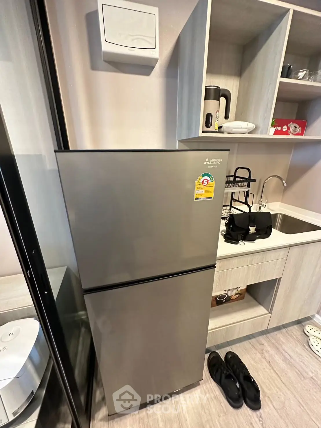 Modern kitchen with sleek fridge and stylish shelving