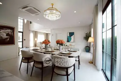 Luxurious dining room with elegant chandelier and modern decor, perfect for entertaining guests.