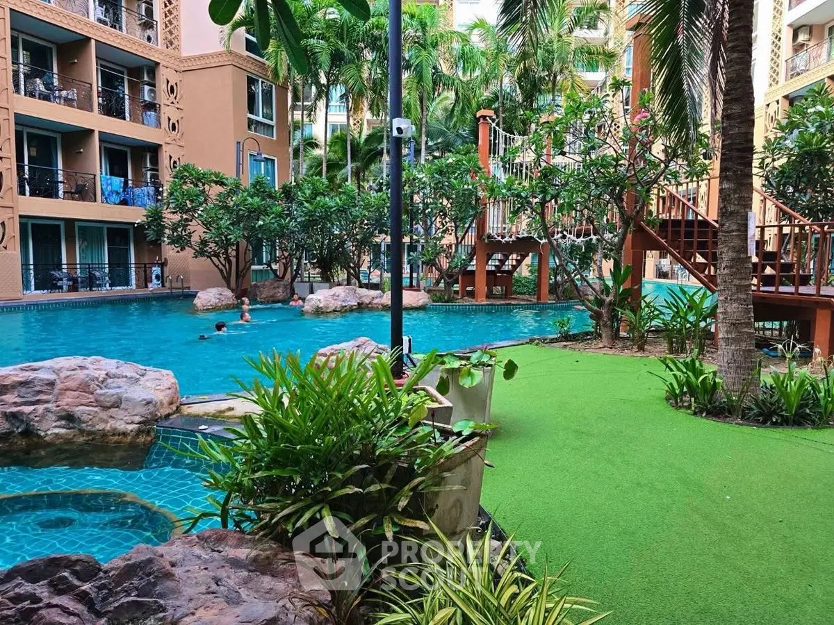 Luxurious apartment complex with stunning pool and lush greenery
