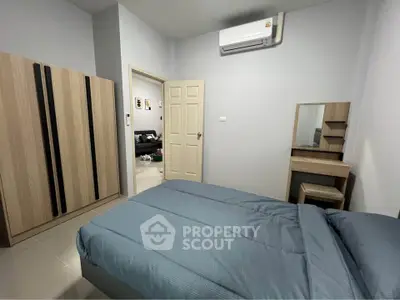 Cozy bedroom with modern furniture and air conditioning in a stylish apartment.