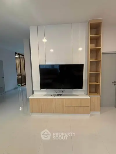 Modern living room with sleek TV unit and built-in shelving