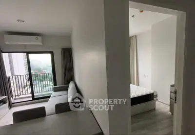 Spacious modern living room with large windows and balcony access