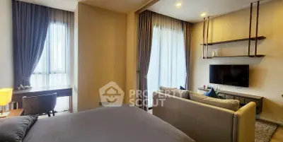 Modern bedroom with cozy seating area and large windows for natural light.