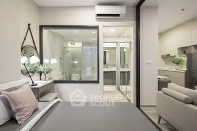 Modern studio apartment with open layout, featuring bedroom, bathroom, and kitchen areas.