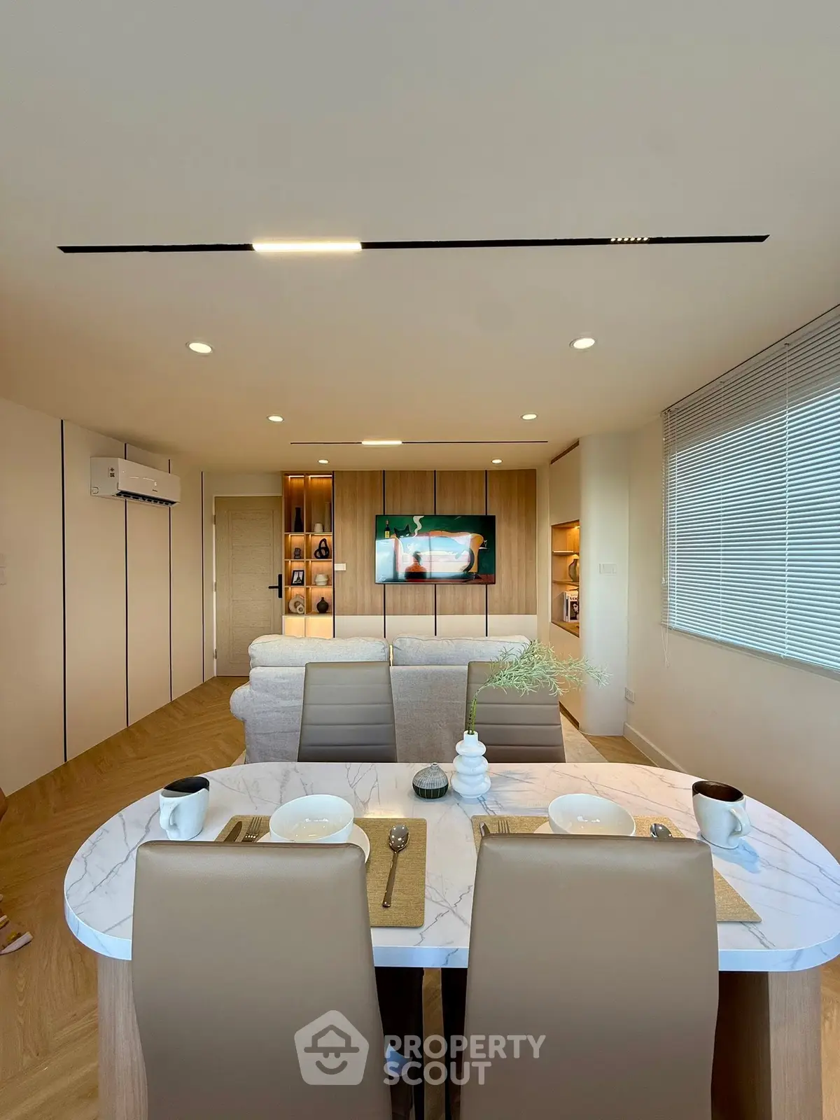 Modern living room with dining area, featuring sleek furniture and stylish decor, perfect for contemporary living.