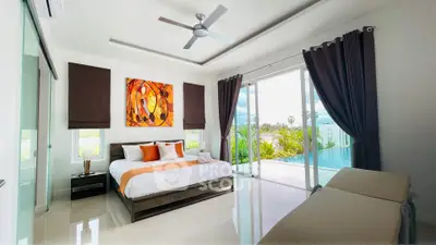 Luxurious bedroom with pool view and modern decor in a serene setting.