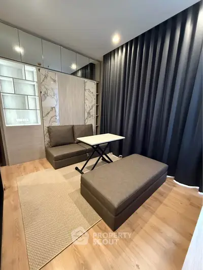 Modern living room with sleek furniture and floor-to-ceiling curtains, perfect for urban living.