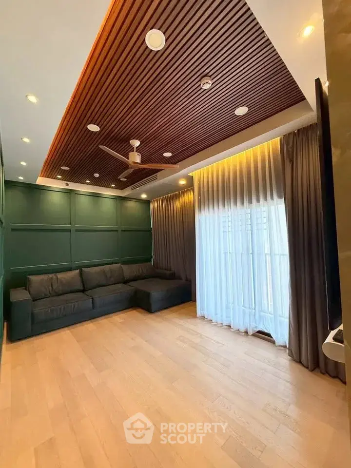 Spacious living room with modern ceiling design and large window