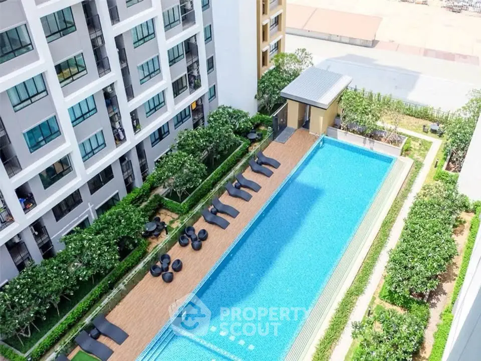 Luxurious apartment complex with stunning pool and lush greenery