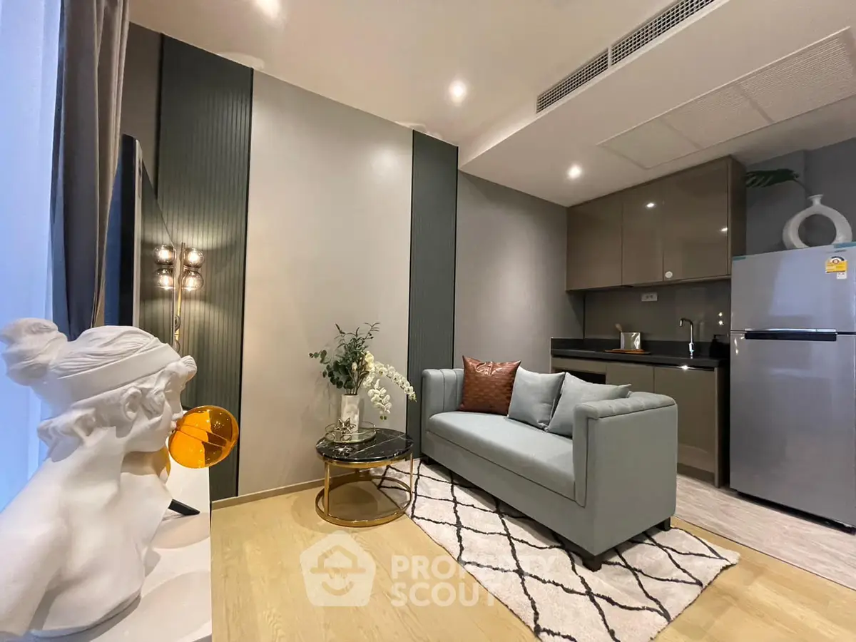 Modern living room with stylish decor and compact kitchen area