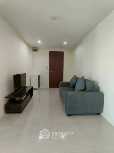 Modern minimalist living room with sleek tile flooring and cozy sofa