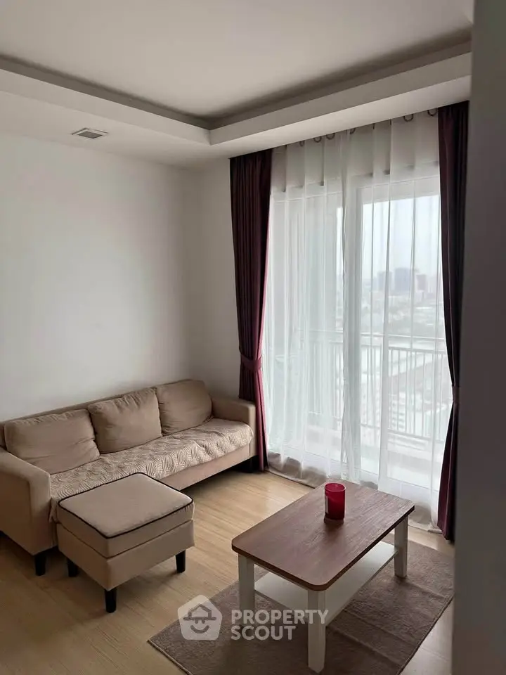 Cozy living room with natural light and modern furniture, featuring a comfortable sofa and stylish coffee table.