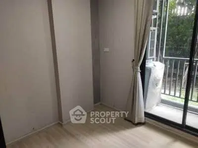 Cozy room with large window and balcony access, perfect for natural light lovers.