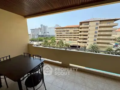 Spacious balcony with city view, perfect for relaxation and dining.