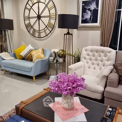 Charming living room with elegant decor, plush seating, and stylish clock wall art for a cozy ambiance.