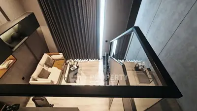Modern loft-style living room with sleek design and floor-to-ceiling windows