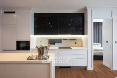 Modern kitchen with sleek white cabinetry and open layout design
