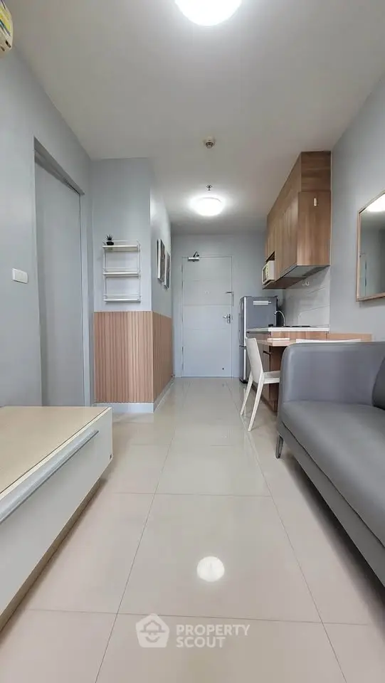 Modern apartment interior with sleek kitchen and cozy living area, perfect for urban living.