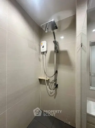 Modern bathroom with sleek shower design and neutral tiles