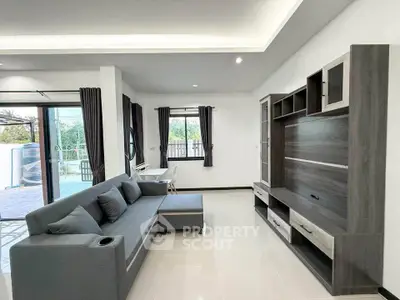 Modern living room with sleek furniture and large windows for natural light