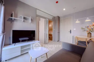 Modern living room with sleek furniture and open layout in a stylish apartment.