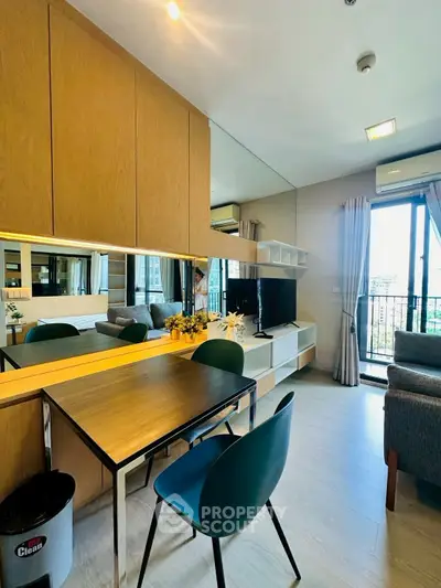 Modern living room with stylish furniture and large windows offering a city view.