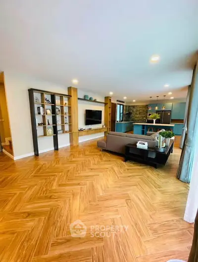 Spacious modern living room with open kitchen and stylish wooden flooring