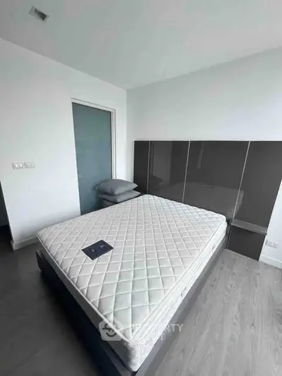 Modern minimalist bedroom with sleek design and comfortable mattress, perfect for restful nights.